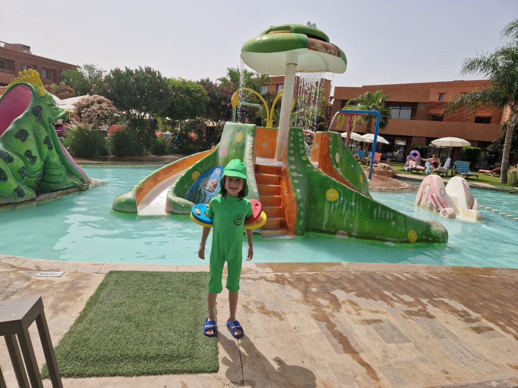 The Pool At Be Live Experience Marrakech Palmeraie We absolutely fell in love with the pool setup at Be Live Experience Marrakech Palmeraie. There's a huge outdoor pool surrounded by sun loungers and parasols on a spacious terrace. Then there's and a separate kids’ pool with a slide and splash park, perfect for families with young children. My son was obsessed with this slide. No, really - he must have gone down it at least 100 times a day! I’m not exaggerating. It was the highlight of every afternoon and kept him happily entertained while I relaxed nearby. The splash park is a fun, safe zone for kids, complete with jets, sprinklers, and shallow paddling areas-ideal for younger ones who just want to splash around. Meanwhile, grown-ups could unwind by the main pool or grab a snack at the adjacent poolside grill. Although some past reviewers mentioned that during peak times the pool area could feel a bit crowded, in our experience it never felt overwhelming - more active than tranquil, but always manageable even during busier moments. If your child loves water play, this is seriously one of the best pools you’ll find in a family-friendly Moroccan resort.